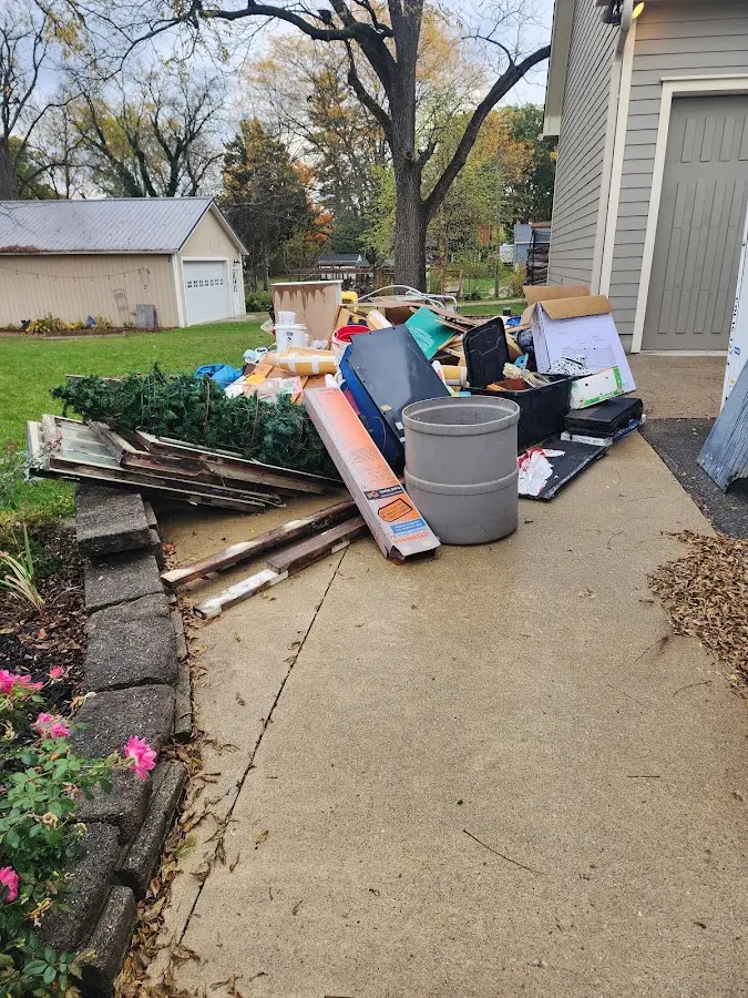 Dumpster being loaded with debris for Estate Cleanout Dumpster Rental in Springtown